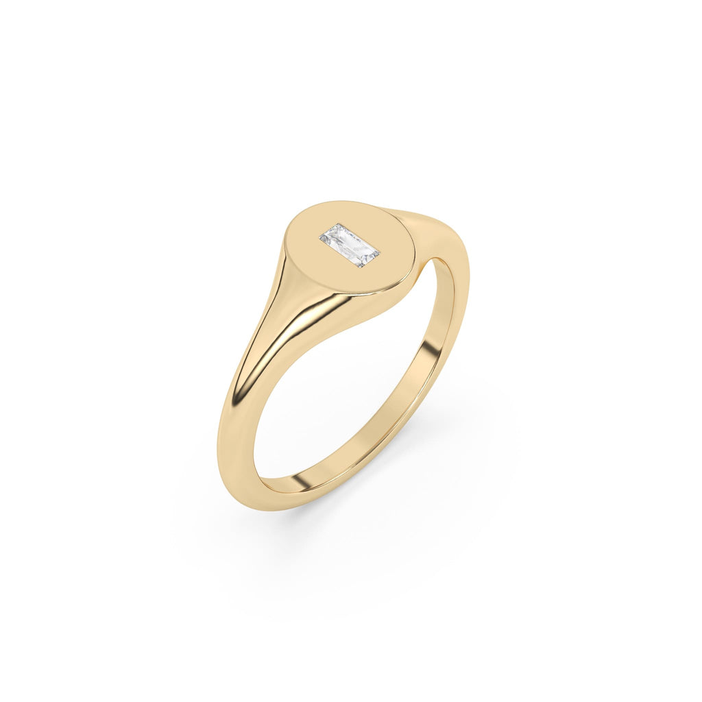 solid gold oval signet ring set with a baguette diamond